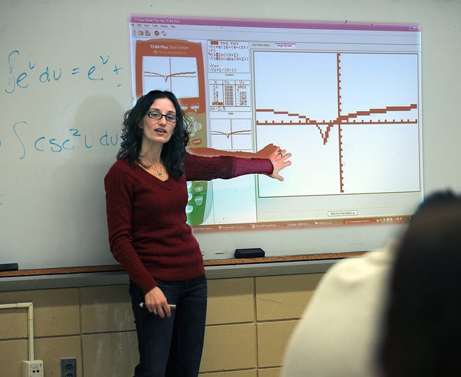 Milford High School math teacher Jennifer Letourneau talks to her class on Friday about her presentation to the School Committee about the Mimio which allows a wall or whiteboard to be a backdrop for an interactive presentation.