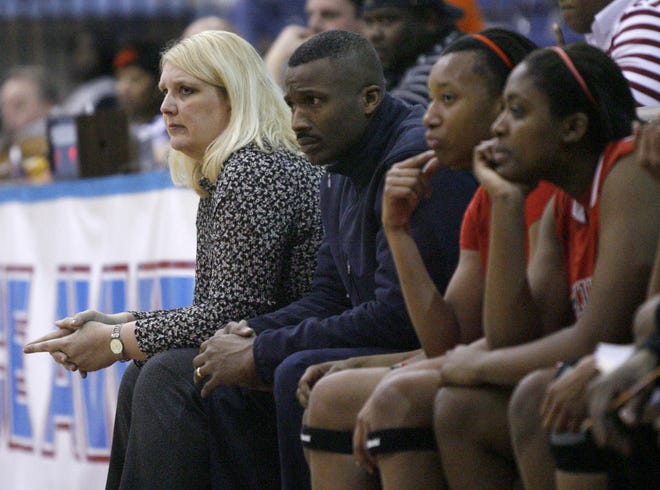 Pam (left) and Willie Davis (second from left) have led the McKinley High School girls to a 74-20 record in four seasons with Pam Davis leading the Bulldogs. The two have enjoyed great success on the court but remain a mystery to most because of their different approaches to coaching.