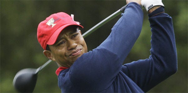 FILE - This Oct. 11, 2009, file photo shows Tiger Woods teeing off at the Presidents Cup at Harding Park Golf Course in San Francisco. Woods is back at home after a week of family counseling in Arizona and is trying to get back into a routine that includes golf and fitness, according to a person with knowledge of his schedule. (AP Photo/Jeff Chiu, File)