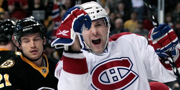 Montreal left wing Mathieu Darche celebrates in front of a dejected Andrew Ference of Boston during the third period of Tuesday night's game. The Bruins took a 1-0 lead into the final period before losing 4-1.