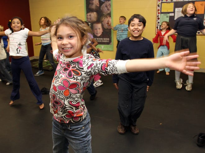 Abigail Negron, 7, does jumping jacks with other children in a fitness class at the Marion County YMCA Family Center on Southeast 17th Street in Ocala on Monday.