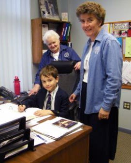 St. James kindergarten student Charlie Keen takes his place at the principal's desk.