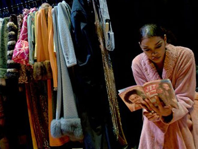 FILE-This Nov. 17, 2005 file photo shows commentator Jada Collins relaxing backstage before the show with a magazine at the 48th Annual Ebony Fashion Fair in Flint, Mich.
