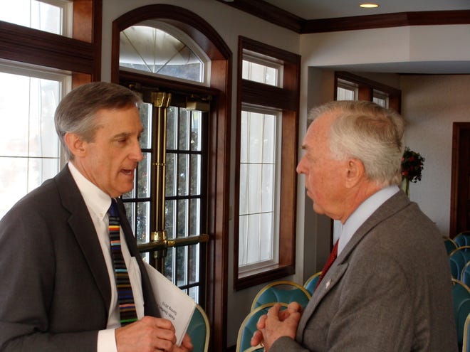 Keith Steffen, left, CEO of OSF Saint Francis Medical Center, speaks with John Bearce following a discussion on the local economy last week at Weaver Ridge. Steffen was among several speakers who voiced an optimistic message about the local economy.