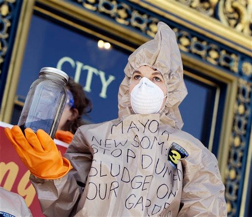 A demonstrator with the Organic Consumers Association hold a jar of city-issued compost on the steps of city hall in San Francisco, Thursday, March 4, 2010. Protesters held the event to speak out against what they believe is contaminated compost issued by the city for use in residents' gardens.