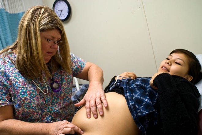 Nurse-midwife Donna Rackley examines Melorie Capitan at the women's clinic 
at the hospital in Tuba City, Ariz.NEW YORK TIMES / ALICE PROUJANSKYE