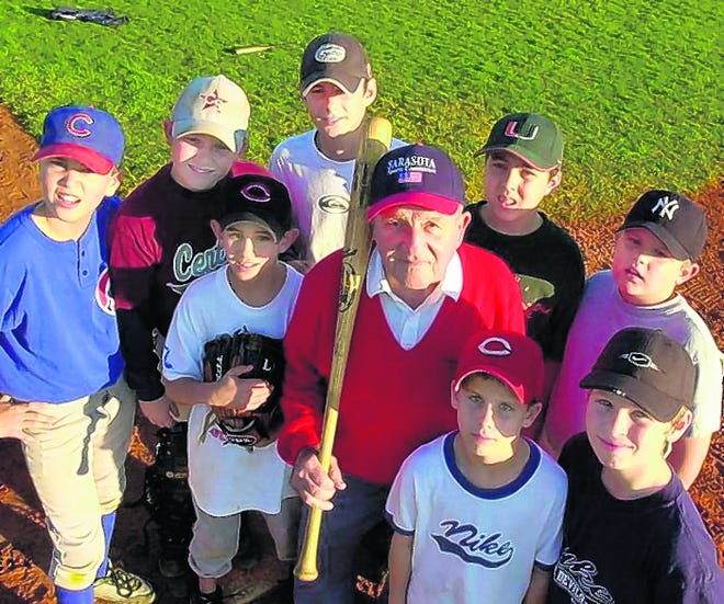 Members of the Cubs Little League baseball team stand with Nick Lucas, president of the Sarasota Sports Committee, in 2002. The sports committee had donated $10,000 to Central Sarasota Little League to build two new ball fields.