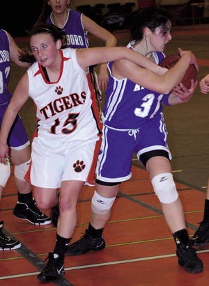 Taunton High senior Courtney George, left, reaches in for a loose ball against an Attleboro player in a game earlier this season.