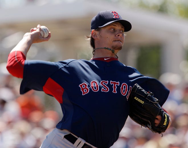 Clay Buchholz delivers in the first inning of the Red Sox' 5-4 Grapefruit League win over the Baltimore Orioles on Sunday.