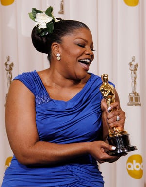 Mo'Nique poses backstage with the Oscar for best performance by an actress in a supporting role for "Precious: Based on the Novel 'Push' by Sapphire" at the 82nd Academy Awards Sunday, March 7, 2010, in the Hollywood section of Los Angeles. (AP Photo/Matt Sayles)