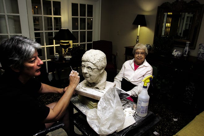 Artist Pam Foley, left, sculpts a clay bust of model Helen Noonan, a resident at The Arbors in Taunton, last summer. The demonstration was part of Foley's artist-in-residency program, which earned her recognition by the Massachusetts Cultural Council.
