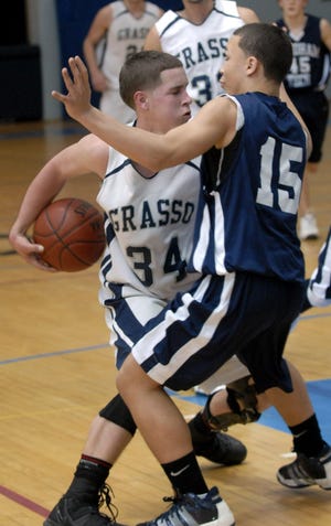 Grasso Tech's Pat Houlihan, left, looks to pass Monday, March 8, 2010 around Windham Tech's Christian Clarke in the second half of their Class S first round basketball tournament in Groton.