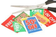 clipping coupons to save money at the grocery store