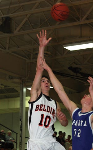 Belding senior Jimmy Scott hits a hook shot over Sparta’s Jake Plite Wednesday night during the Redskins’ district semifinal game against the Spartans at Belding High School.