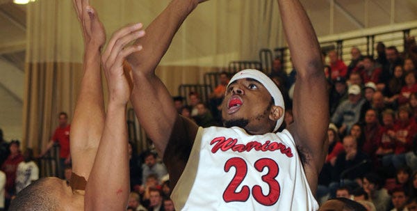 East Stroudsburg University's Terrance King shoots the ball over IUP's Darryl Webb on Friday night, March 5, 2010, in the PSAC semifinal game.