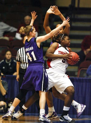 Kansas State's Kari Kincaid, left, and Jalana Childs, back, trap Texas Tech guard Christine Hyde as she drives to the basket during the Big 12 women's tournament Thursday in Kansas City, Mo.