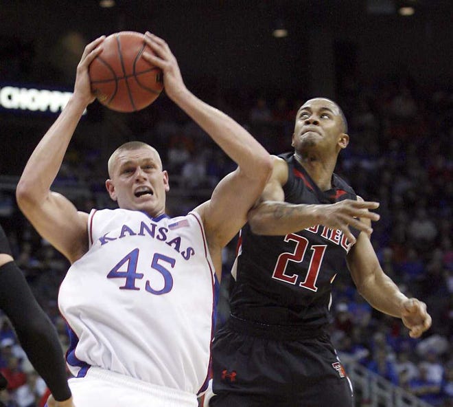 Kansas center Cole Aldrich (45) pulls down one of his 18 rebounds against Texas Tech's John Roberson (21) during KU's 80-68 win Thursday in the Big 12 Tournament.