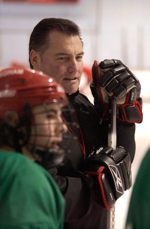 Hingham's Boys Hockey Head Coach Tony Messina watches his team take in a practice session Monday at Hingham's Pilgrim Arena.