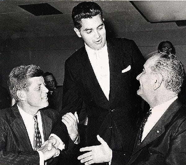 Senator John F. Kennedy, left, Democratic presidential nominee, and Sen. Lyndon Johnson greet District Attorney Edmund Dinis in September of 1960.