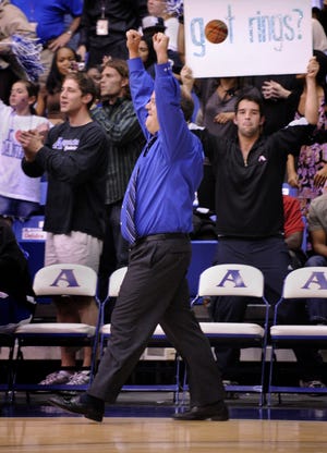 Augusta State coach Dip Metress raises his fists in celebration after Fred Brathwaite sealed the Jaguars' win over Montevallo with a breakaway dunk at Christenberry Fieldhouse on Tuesday.