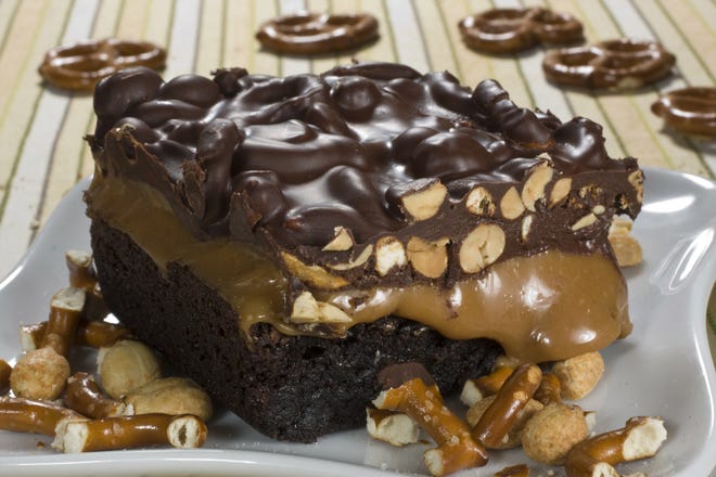 Don't stop with a great boxed brownie mix. Keep going till you get a brownie that makes you yell OMG. Salted caramel crunch brownies ooze caramel between a top layer of pretzel and peanut-filled chocolate and a bottom layer of moist brownie. (AP Photo/Larry Crowe)