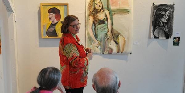 Jeanne Quigley of Alzheimer’s Services of Cape Cod and the Islands talks about art by Guyer Barn last week.