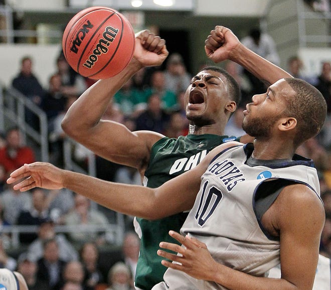 Ohio's DeVaughn Washington, rear, celebrates his dunk past Georgetown's Greg Monroe (10) during the first half of Thursday's first-round game in Providence, R.I.