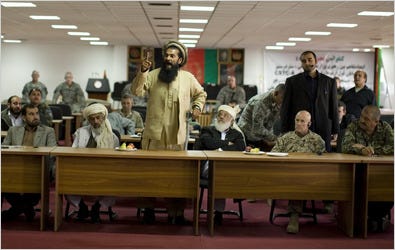 Cmdr. Dawood Zazai, center, objected on Monday to a clause justifying detentions by the United States. “Who proved that these men were guilty?” he asked.