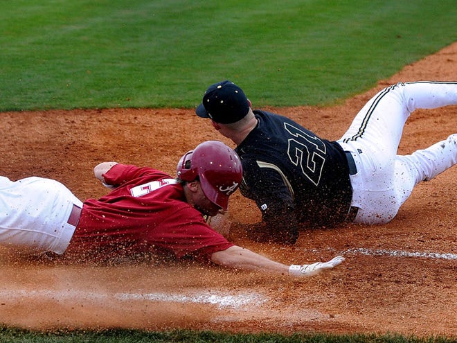 Alabama's Josh Rutledge (2) is is tagged out at first base on a diving attempt by Vanderbilt pitcher Adam Windsor during the sixth inning of college baseball action Sunday afternoon at Sewell-Thomas Stadium in Tuscaloosa, AL.