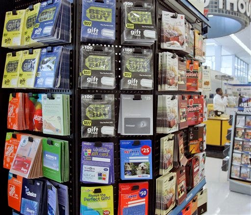 In this Jan. 10, 2008 file photo, gift cards for various retailers are offered for sale at a supermarket in Omaha, Neb. The Federal Reserve issued new rules on Tuesday, March 23, 2010, to protect Americans from getting stung by unexpected fees or restrictions on gift cards.