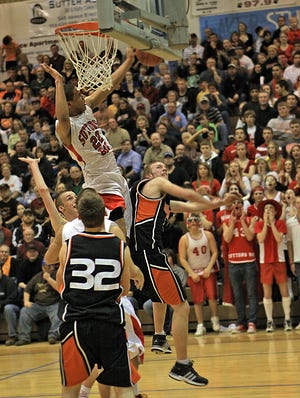 Dwuan Anderson of Suttons Bay blocks a shot by Rudyard's Drew Otten during Tuesday's quarterfinal.