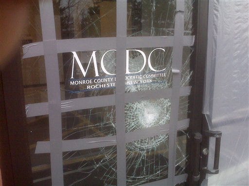 This picture provided on Wednesday, March 24, 2010 by the Monroe County Democratic Committee in Rochester, N.Y. shows damage to their office after a glass door was struck with a brick with a note reading "Exremism in Defense of Liberty Is no Vice" sometime from late Saturday, March 20, 2010 or Sunday, March 21, 2010. Bricks have been hurled through Democrats' windows, a propane line was cut at the home of a congressman's brother and lawmakers who voted for a federal health care bill have received phone threats in the days before and after passage of the sweeping legislation.