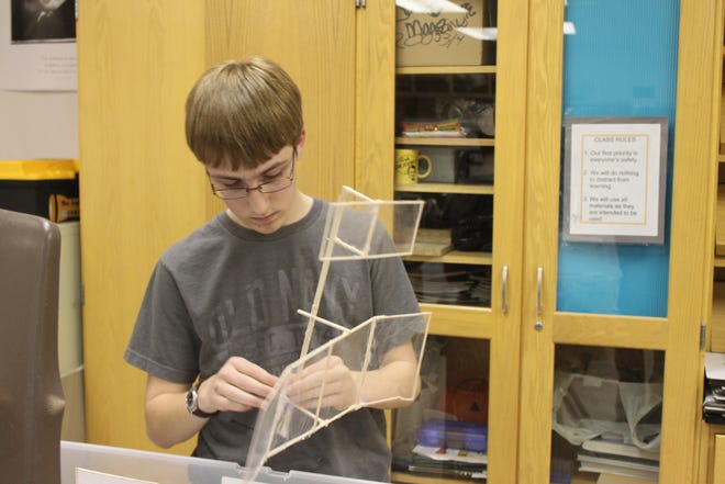 Nick Stiles, IHS freshman, is working on the team’s Wright Stuff airplane, which is made out of balsa wood and plastic wrap.