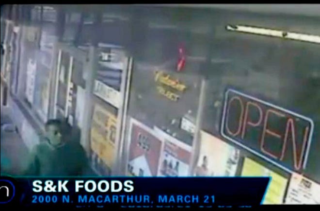 Oklahoma City police said the person shown in surveillance video from S.K. Foods appears to be keeping watch while a robbery and killing happen inside the store on Sunday night. Photo provided