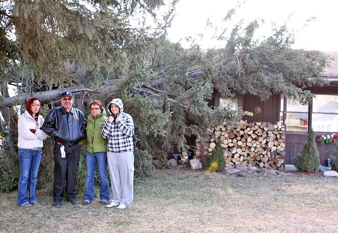 The Swanson family, Keena, Roy, Laurie and Kylee had an unwanted visitor early this morning when a neighbor’s tree fell on their home. There were six people inside the home at the time of the incident and all escaped unscathed.