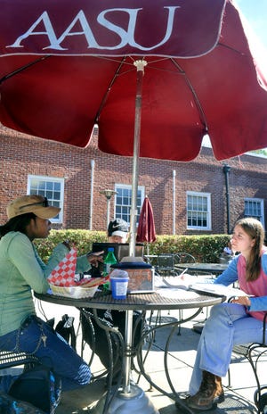 Elizabeth Rhaney, left, Michael Stokes, middle, and Lexsie Fulcher, right, study during lunch on Armstrong Atlantic State University's campus on Friday afternoon. Suzannah Hoover/Savannah Morning News.