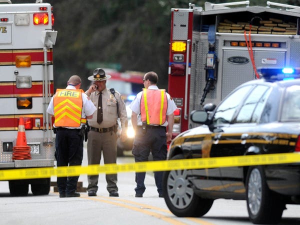 Emergency personnel stand at the scene of a motorcycle accident along Myrtle Grove Rd. in Wilmington on March 25. Michael Douglas Spohn, 50, of Carolina Beach died as a result of the wreck.
