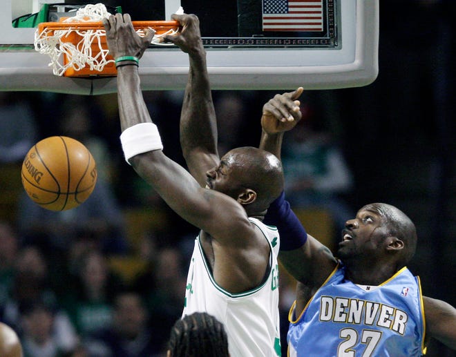 Celtics forward Kevin Garnett dunks against the Nuggets' Johan Petro during the first half of Wednesday's game in Boston.