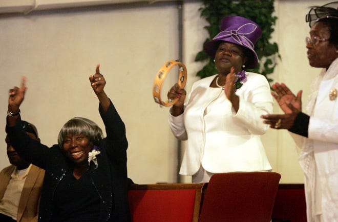 The congregation of Pleasant Hill Missionary Baptist Church sings and worships during the morning worship service on Mission Day at the church .