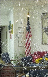 This photo provided by the office of Representative Gabrielle Giffords of Arizona shows damage to her Tucson office.