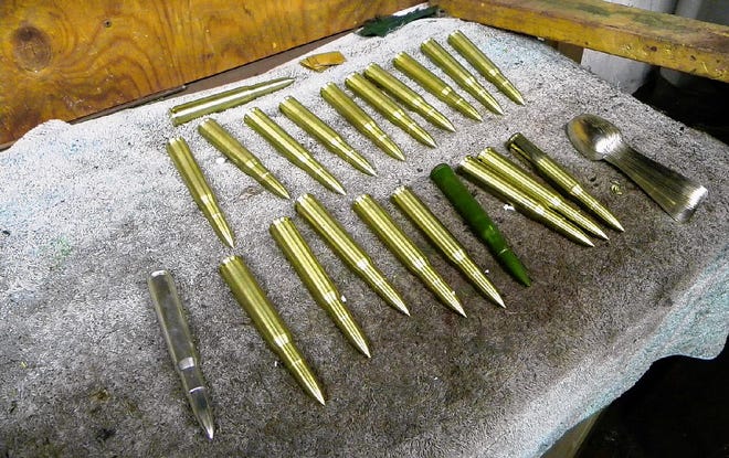 A collection of bullets machined from brass are ready for buffing at Thome Silversmith in East Stroudsburg. The bullets are props for a two-times-size model of a Browning automatic rifle that belongs to a man in New York City.