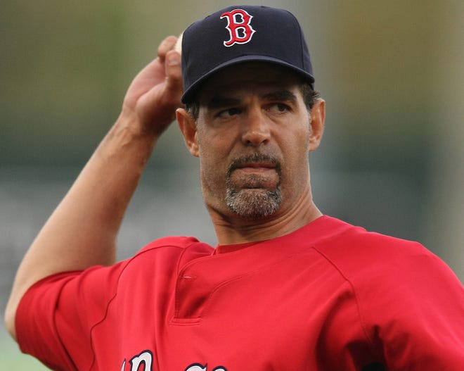 The Red Sox's Mike Lowell warms up prior to Monday's spring training game against the Rays in Fort Myers, Fla. Lowell is likely to see a diminished role in the Boston lineup this season.