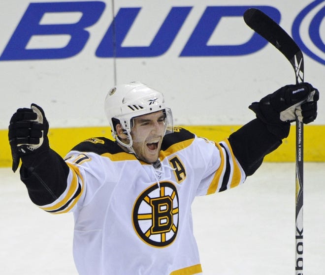 The Bruins' Patrice Bergeron celebrates his goal during overtime to give the Bruins a 1-0 win over the Devils in Tuesday's game in Newark, N.J.