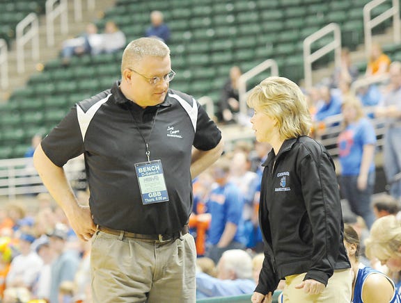 Lenawee Christian coach Joe Long, left, talks with assistant Cheri Smith on the sidelines during the Class D state semifinal at the Breslin Center. Long was selected the county’s Coach of the Year.