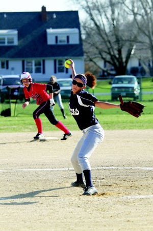 M-R's Jalynne Young pitches while United's Gina Long waits on second base.