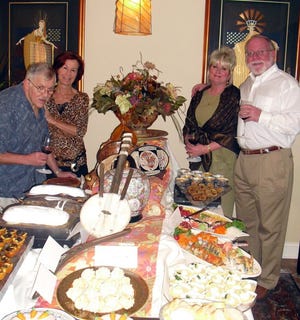 Host and hostess Rene (from left) and Esther Schiegg provided a tasty spread of hors d'oeuvres from the Southern hemisphere at a gathering of the Societe Mondiale du Vin at their Ponte Vedra Beach home. Christie and Bob Gray, the Mondiale chapter leader, hold tastings of fine wines at members' homes.