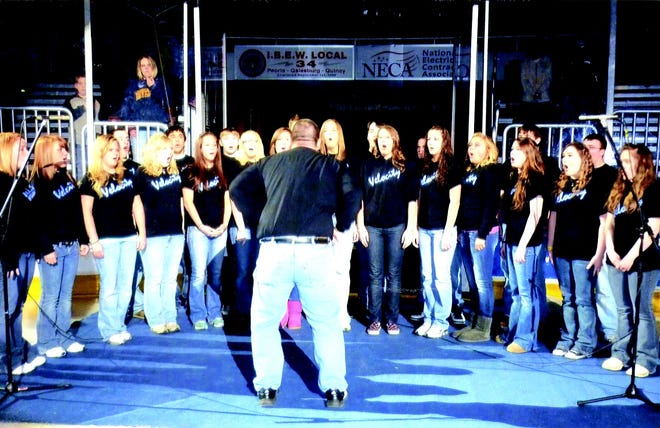 Kevin Ferry leads the Monmouth-Roseville Velocity Choir in the National Anthem before 6025 fans at Sunday's Peoria Rivermen versus Houston Aeros hockey game.