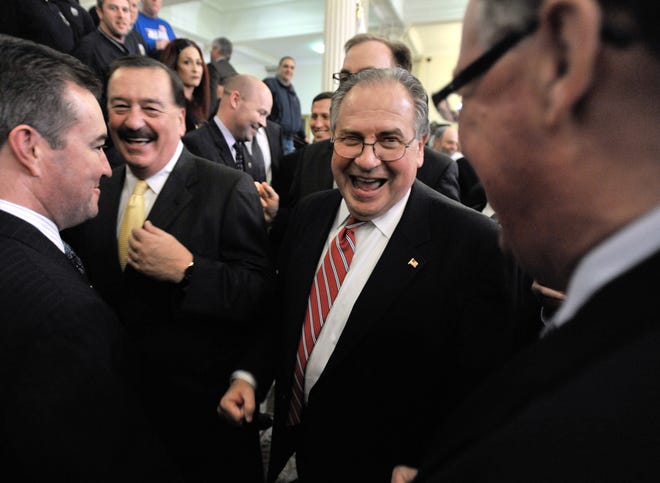 House Speaker Robert A. DeLeo, center, shares a laugh with his supporters after announcing his proposal to allow gambling casinos and slot machine parlors at racetracks in Massachusetts at a news conference at the Statehouse in Boston on Thursday.