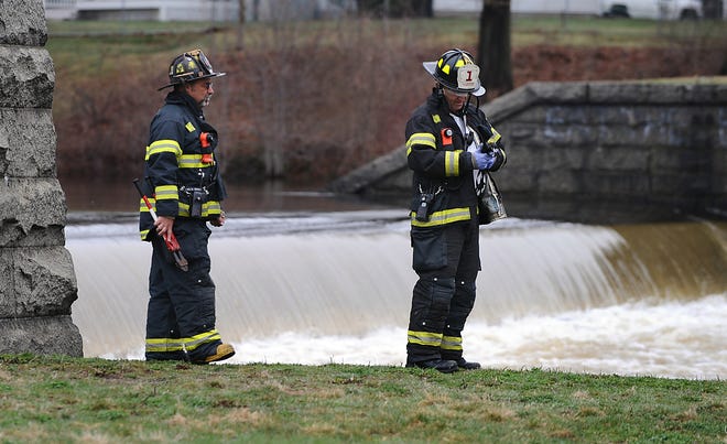 Framingham firefighters respond to the Winter Street dam after an odor of gas was detected coming from a sewer drain near the dam Thursday morning.