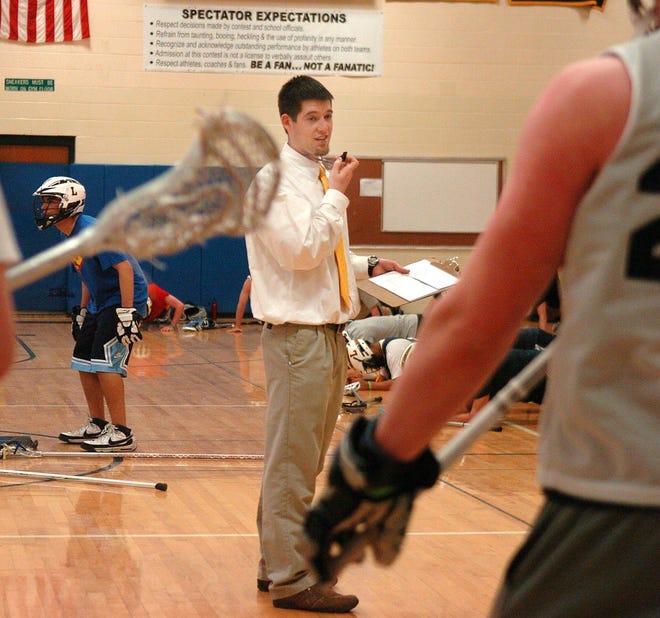 Brian Martin, head coach of the Ledyard lacrosse team, directs players during practice at Ledyard High School Wednesday, March 31, 2010.